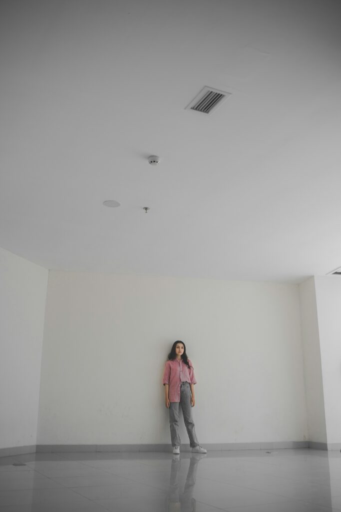 Young woman standing in an empty room